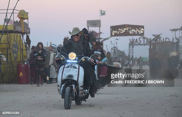 Festival goers attend the first day of Wasteland Weekend in the high desert community of California City in the Mojave Desert, California, where...