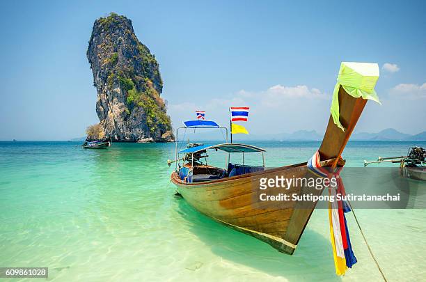 long tailed boat ruea hang yao on beautiful deep blue sea and blue sky in front of island background in phuket thailand - phuket ストックフォトと画像