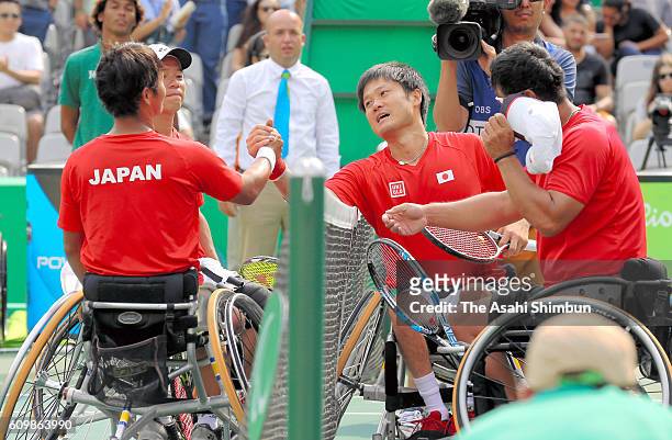 Shingo Kunieda and Satoshi Saida of Japan shake hands with Takuya Miki and Takashi Sanada after winning the bronze medals in the Wheelchair Tennis...