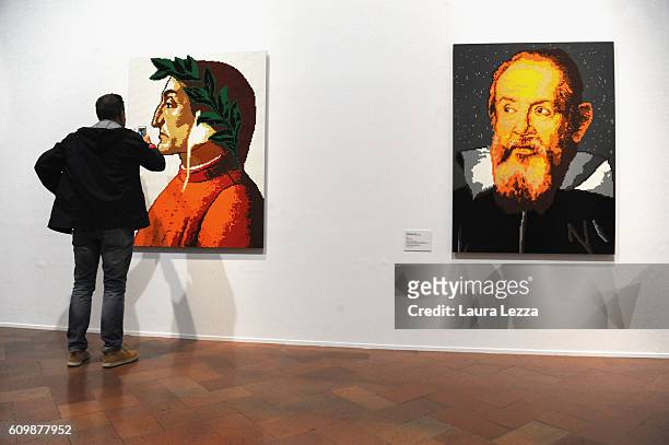 People walk through an installation by the Chinese artist Ai Weiwei concerning portraits of dissidents made by Lego displayed in Palazzo Strozzi on...