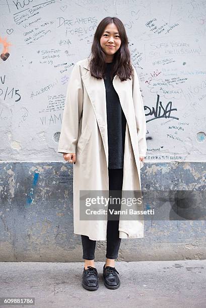 Stylist Noey Park poses wearing a trenchcoat before the Fay show during Milan Fashion Week Spring/Summer 2017 on September 21, 2016 in Milan, Italy.