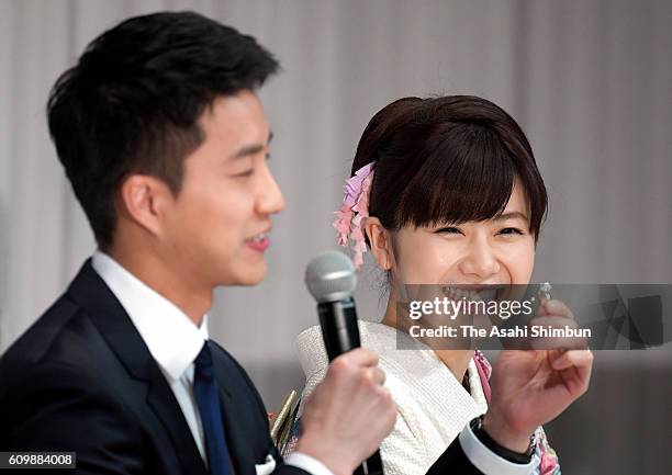 Table tennis players Ai Fukuhara and Hung-Chieh Chiang speak during as Chiang holds a ring at the press conference on September 21, 2016 in Tokyo,...