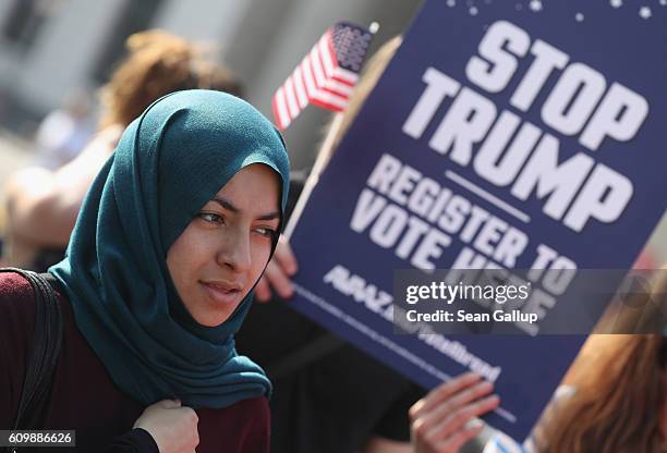 Young Muslim woman attends an event in which activists protesting against Republican U.S. Elections candidate Donald Trump urged U.S. Citizens abroad...