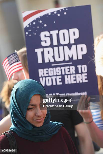 Young Muslim woman attends an event in which activists protesting against Republican U.S. Elections candidate Donald Trump urged U.S. Citizens abroad...