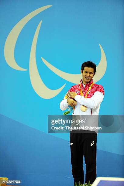 Bronze medalist Keiichi Kimura of Japan celebrates on the podium at the medal ceremony for the Men's 100m Freestyle - S11 on day 8 of the 2016 Rio...