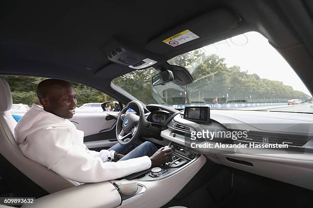 Former world record holder Wilson Kipsang of Kenya, top favorites of the 43. BMW Berlin Marathon 2016 drives a BMW i8 at the Siegessaeule on...