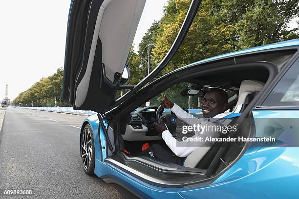 Emmanuel Mutai of Kenya, top favorites of the 43. BMW Berlin Marathon 2016 drives a BMW i8 at the Siegessaeule on September 23, 2016 in Berlin,...