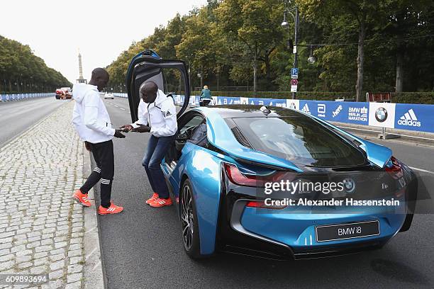 Former world record holder Wilson Kipsang of Kenya and Emmanuel Mutai of Kenya drive a BMW i8 at the Siegessaeule on September 23, 2016 in Berlin,...