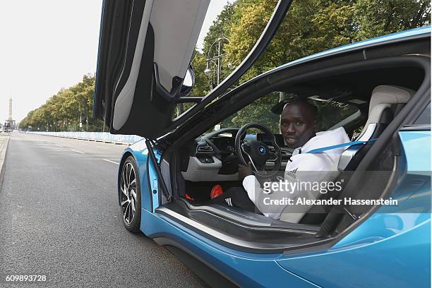 Emmanuel Mutai of Kenya, top favorites of the 43. BMW Berlin Marathon 2016 drives a BMW i8 at the Siegessaeule on September 23, 2016 in Berlin,...
