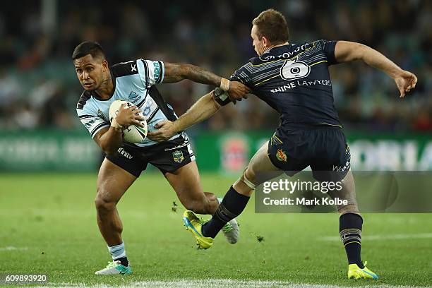 Ben Barba of the Sharks steps around the tackle of Michael Morgan of the Cowbys during the NRL Preliminary Final match between the Cronulla Sharks...