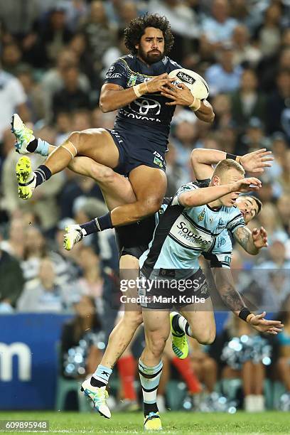 Javid Bowen of the Cowboys wins the ball over Luke Lewis and Jack Bird of the Sharks during the NRL Preliminary Final match between the Cronulla...