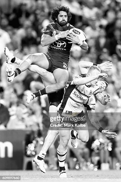 Javid Bowen of the Cowboys wins the ball over Luke Lewis and Jack Bird of the Sharks during the NRL Preliminary Final match between the Cronulla...