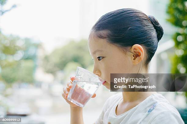 girl drinking glass of water - freshwater stock pictures, royalty-free photos & images