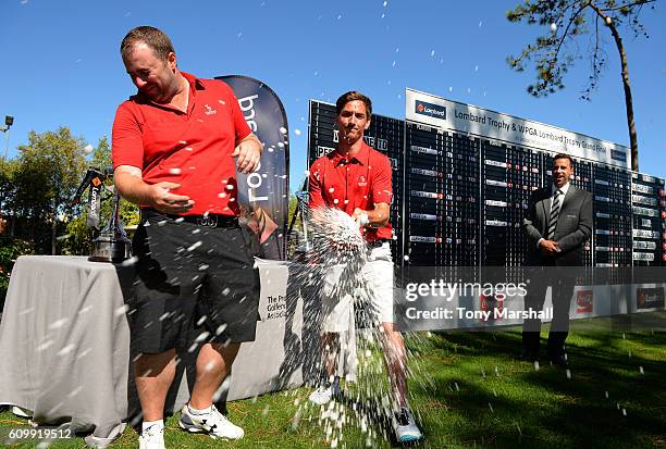 Adam Powell and Matt Leach of Hartford Golf Club celebrate winning The PGA Lombard Trophy with Champagne during the Lombard Trophy Final Day Two at...