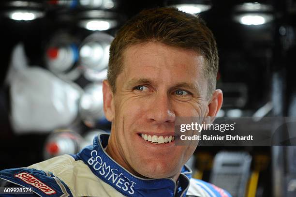 Carl Edwards, driver of the Comcast Business Toyota, stands in the garage during practice for the NASCAR Sprint Cup Series Bad Boy Off Road 300 at...