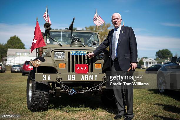 John McCain, R-Ariz., poses with a jeep during a campaign event for Sen. Pat Toomey, R-Pa., at the Herbert W. Best VFW Post 928 in Folsom, Pa.,...