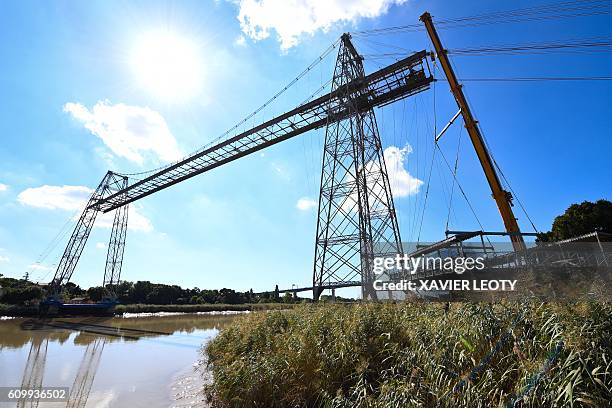 This image taken September 23, 2016 in Rochefort shows an engineer using a guide rope at the start of a three year restoration project on the last...