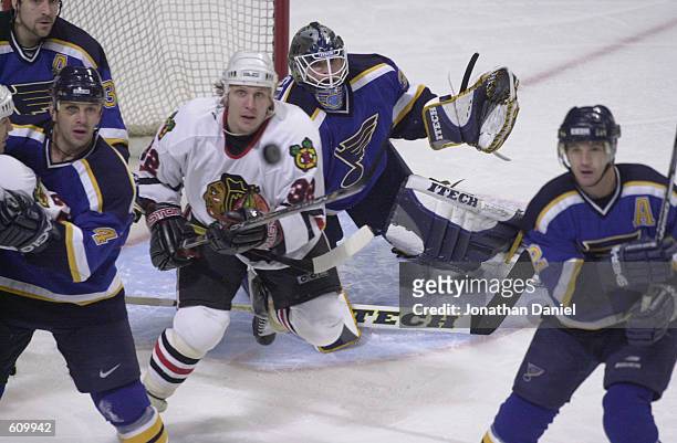 Goalie Brent Johnson of the St. Louis Blues defends the net against Steve Thomas of the Chicago Blackhawks in game four of the Stanley Cup playoffs...