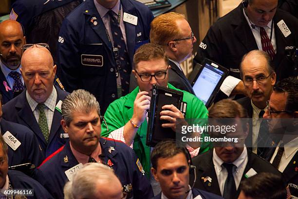 Traders work on the floor of the New York Stock Exchange in New York, U.S., on Friday, Sept. 23, 2016. U.S. Stocks slipped as investors considered...