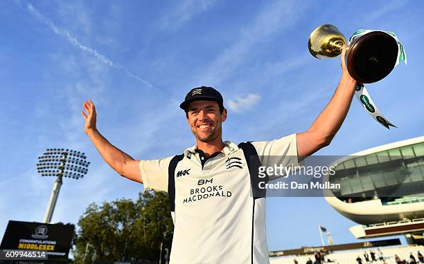 James Franklin of Middlesex poses with the County Championship Trophy following victory during day four of the Specsavers County Championship match...