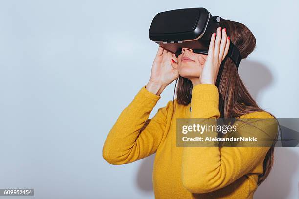 jovem mulher a utilizar óculos de realidade virtual - vr imagens e fotografias de stock