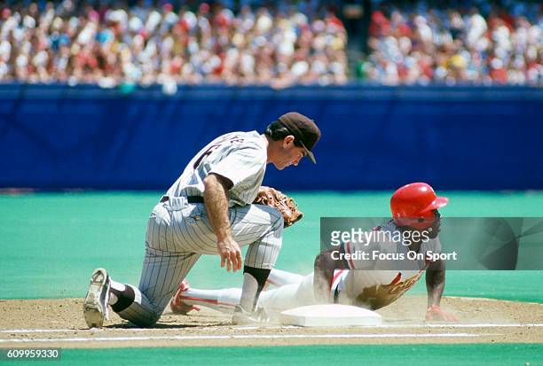 Vince Coleman of the St Louis Cardinals dives into first base as Steve Garvey of the San Diego Padres take the throw over during an Major League...