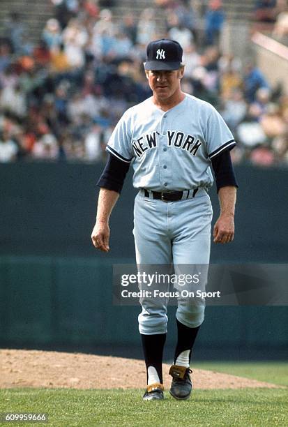 Pitching coach Whitey Ford of the New York Yankees after a visit to the mound walks back to the dugout against the Baltimore Orioles during an Major...