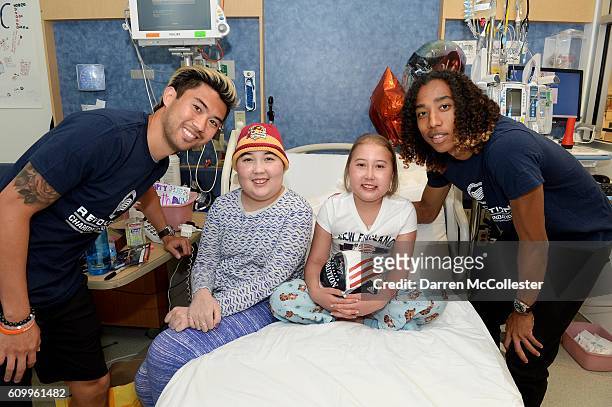 New England Revolution players Lee Nguyen and Zachary Herivaux visit Maddie and Grace at Boston Children's Hospital September 21, 2016 in Boston,...
