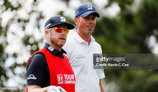 Matt Kuchar waits with his caddie John Wood on the first hole during the second round of the TOUR Championship at East Lake Golf Club on September...