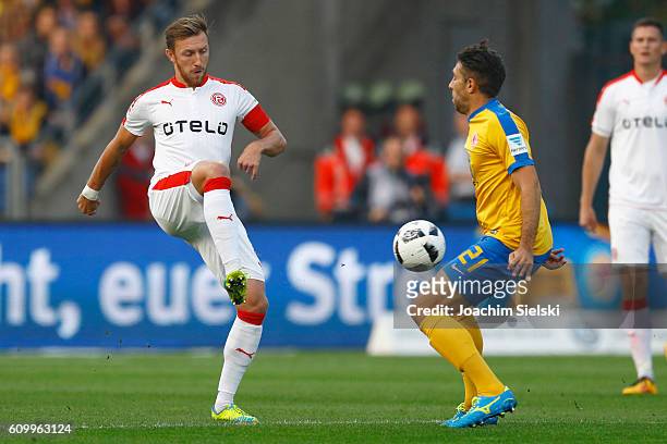 Patrick Schoenfeld of Braunschweig challenges Adam Bodzek of Duesseldorf during the Second Bundesliga match between Eintracht Braunschweig and...