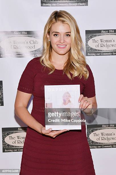 Author/Television personality Daphne Oz signs copies of her new book "The Happy Cook" at Women's Club Of Ridgewood on September 23, 2016 in...