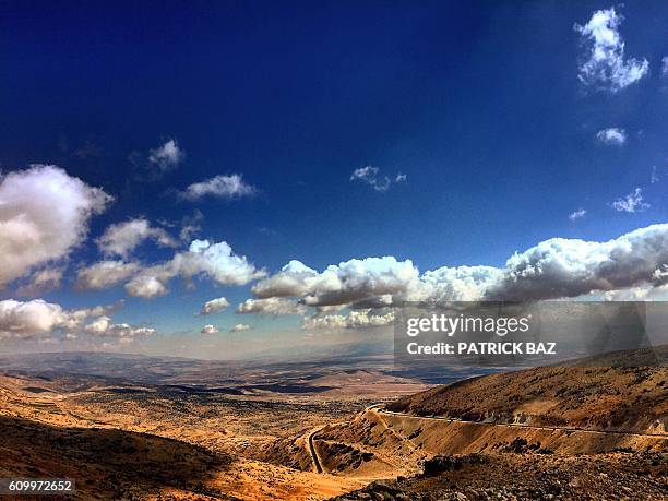 General view taken on September 23, 2016 shows the road leading from Lebanon's mountainous hills of Ouyoun al-Siman to the Bekaa Valley. / AFP /...