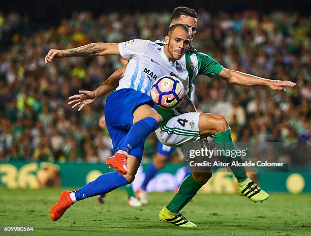 Sandro Ramirez of Malaga CF competes for the ball with Bruno Gonzalez of Real Betis Balompie during the match between Real Betis Balompie vs Malaga...