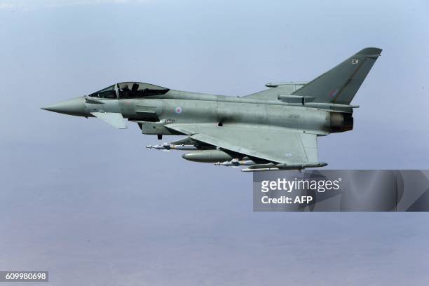 This photo taken on September 21, 2016 shows a Britain's Royal Air Force Eurofighter Typhoon fighter jet in flight during a coalition mission over...