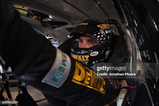 Daniel Suarez, driver of the DEWALT FLEXVOLT Toyota, sits in his car during practice for the NASCAR XFINITY Series VysitMyrtleBeach.com 300 at...