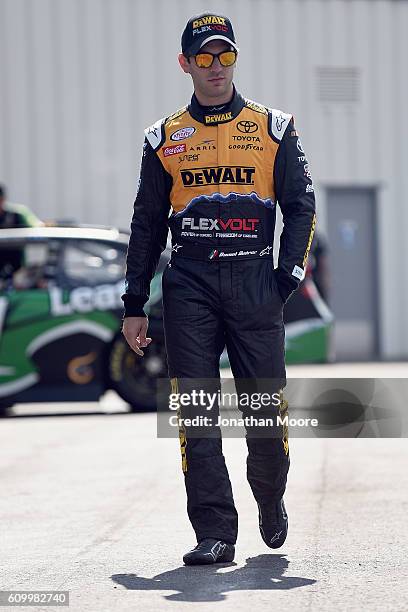 Daniel Suarez, driver of the DEWALT FLEXVOLT Toyota, walks in the garage during practice for the NASCAR XFINITY Series VysitMyrtleBeach.com 300 at...