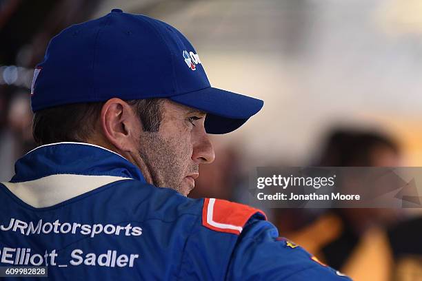 Elliott Sadler, driver of the OneMain Chevrolet, stands inside the garage during practice for the NASCAR XFINITY Series VysitMyrtleBeach.com 300 at...