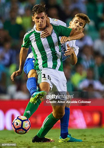 Alex Alegria of Real Betis Balompie competes for the ball with Diego Llorente of Malaga CF during the match between Real Betis Balompie vs Malaga CF...