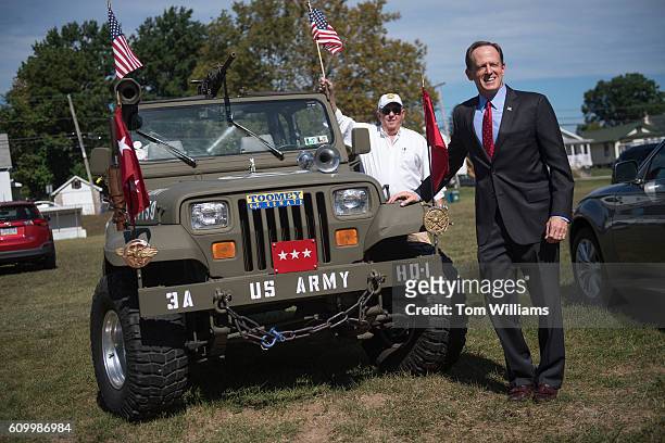 Sen. Pat Toomey, R-Pa., poses with a military-style Jeep during a campaign event at the Herbert W. Best VFW Post 928 in Folsom, Pa., September 23,...