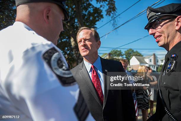 Sen. Pat Toomey, R-Pa., center, talks with police officers during a campaign event at the Herbert W. Best VFW Post 928 in Folsom, Pa., September 23,...