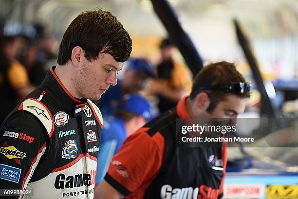 Erik Jones, driver of the GameStop Toyota, stands in the garage during practice for the NASCAR XFINITY Series VysitMyrtleBeach.com 300 at Kentucky...