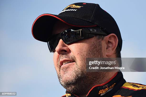 Brendan Gaughan, driver of the South Point Chevrolet, stands in the garage during practice for the NASCAR XFINITY Series VysitMyrtleBeach.com 300 at...