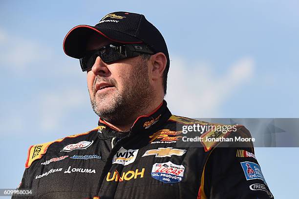 Brendan Gaughan, driver of the South Point Chevrolet, stands in the garage during practice for the NASCAR XFINITY Series VysitMyrtleBeach.com 300 at...