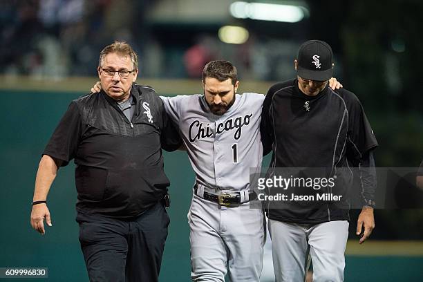Trainer Herm Schneider and manager Robin Ventura help Adam Eaton of the Chicago White Sox off the field after Eaton hit the centerfield wall making a...
