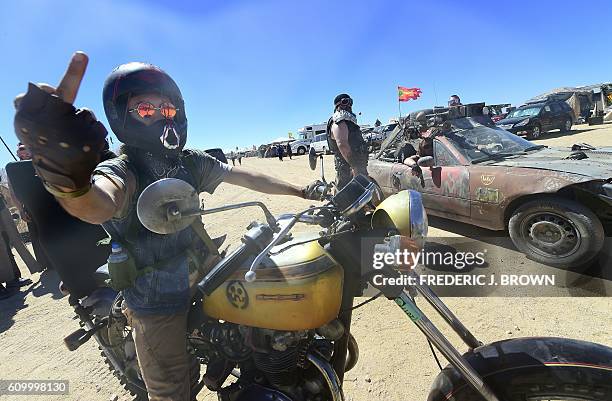 The middle finger greeting is offered as festival goers attend day two of Wasteland Weekend in the high desert community of California City in the...