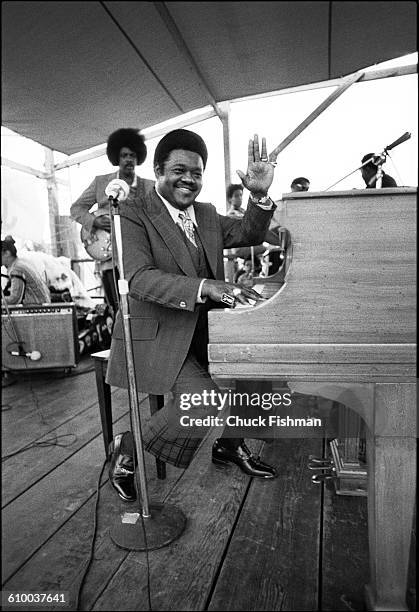 American R&B musician Fats Domino plays piano as he performs onstage during the New Orleans Jazz & Heritage Festival at the Fair Grounds Race Course,...