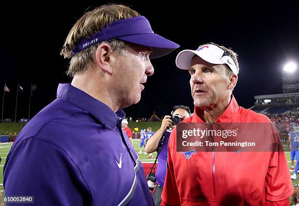 Head coach Gary Patterson of the TCU Horned Frogs talks with head coach Chad Morris of the Southern Methodist Mustangs at midfield after the TCU...