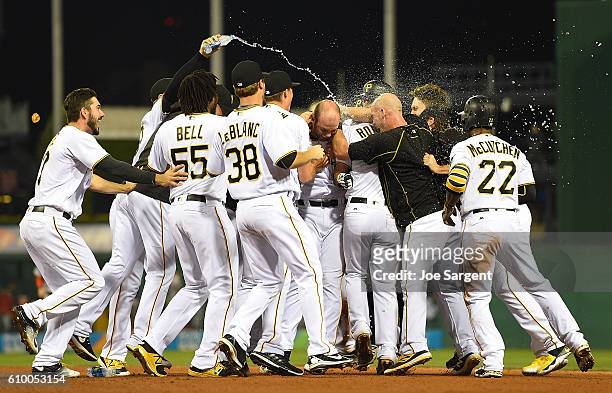 Jacob Stallings of the Pittsburgh Pirates celebrates his game winning RBI single with teammates during the eleventh inning against the Washington...