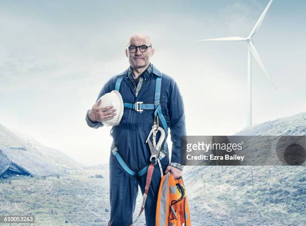portrait of a wind turbine engineer. - mann stolz stock-fotos und bilder
