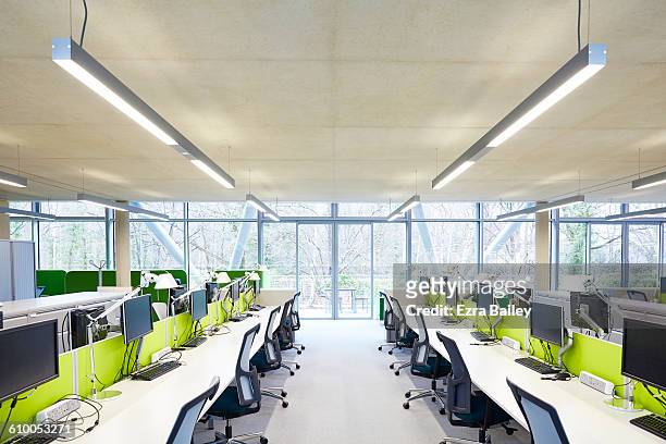 modern open plan office with hot desks. - hot desking stock pictures, royalty-free photos & images